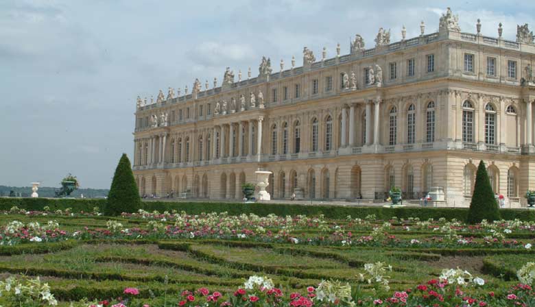 Flowered gardens of Versailles in front of the Palace