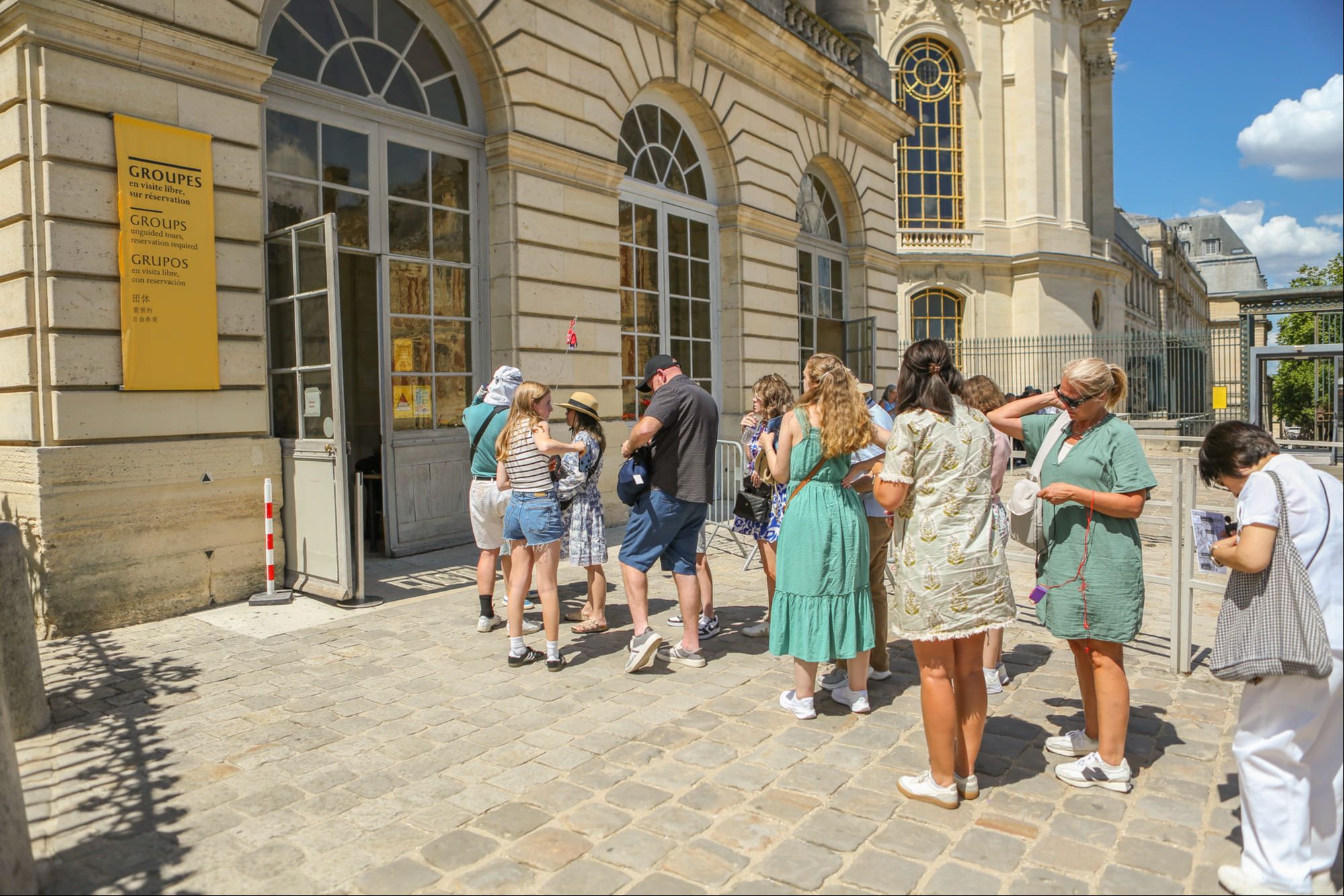 Group entering the Palace of Versailles with a guide