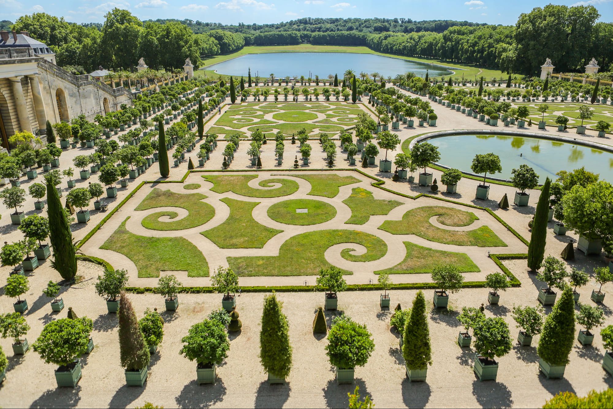Gardens of the Palace of Versailles designed by André Le Nôtre during a sunny day on summer